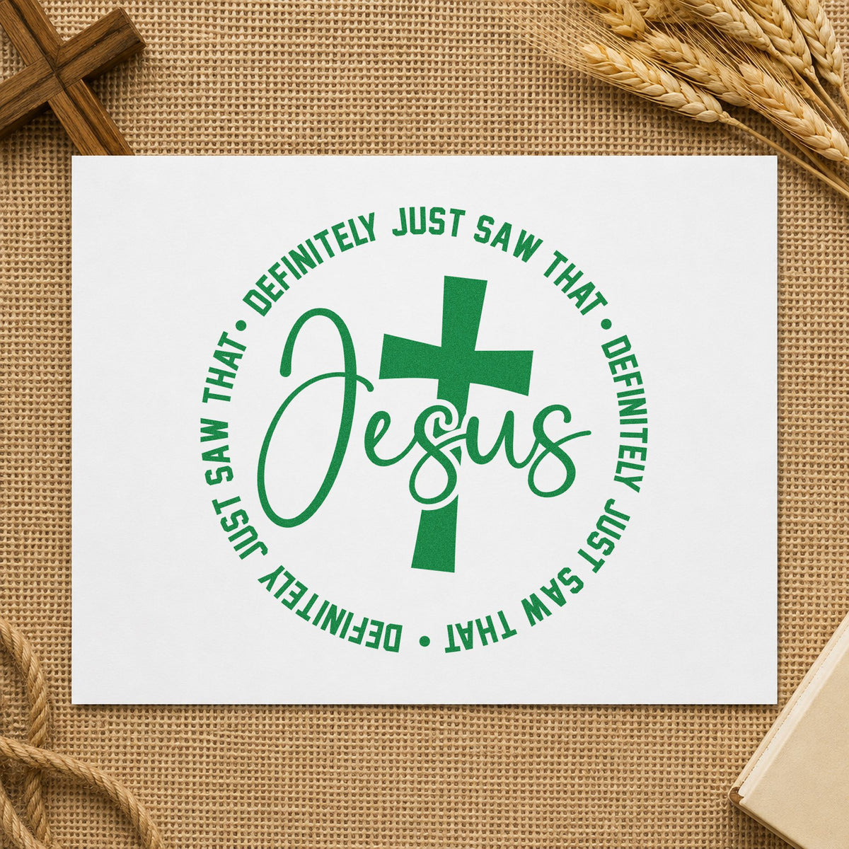 Jesus Definitely Saw That craft stamp imprint in green ink on a handmade project, one idea being youth group tees.