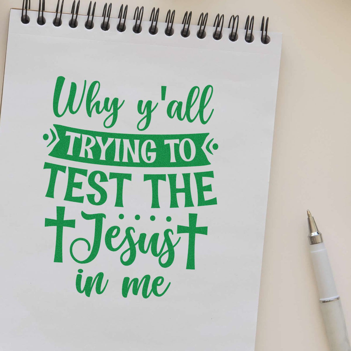 Green rubber stamp design with quote, Why yall trying to test the Jesus in me, on a notebook page.