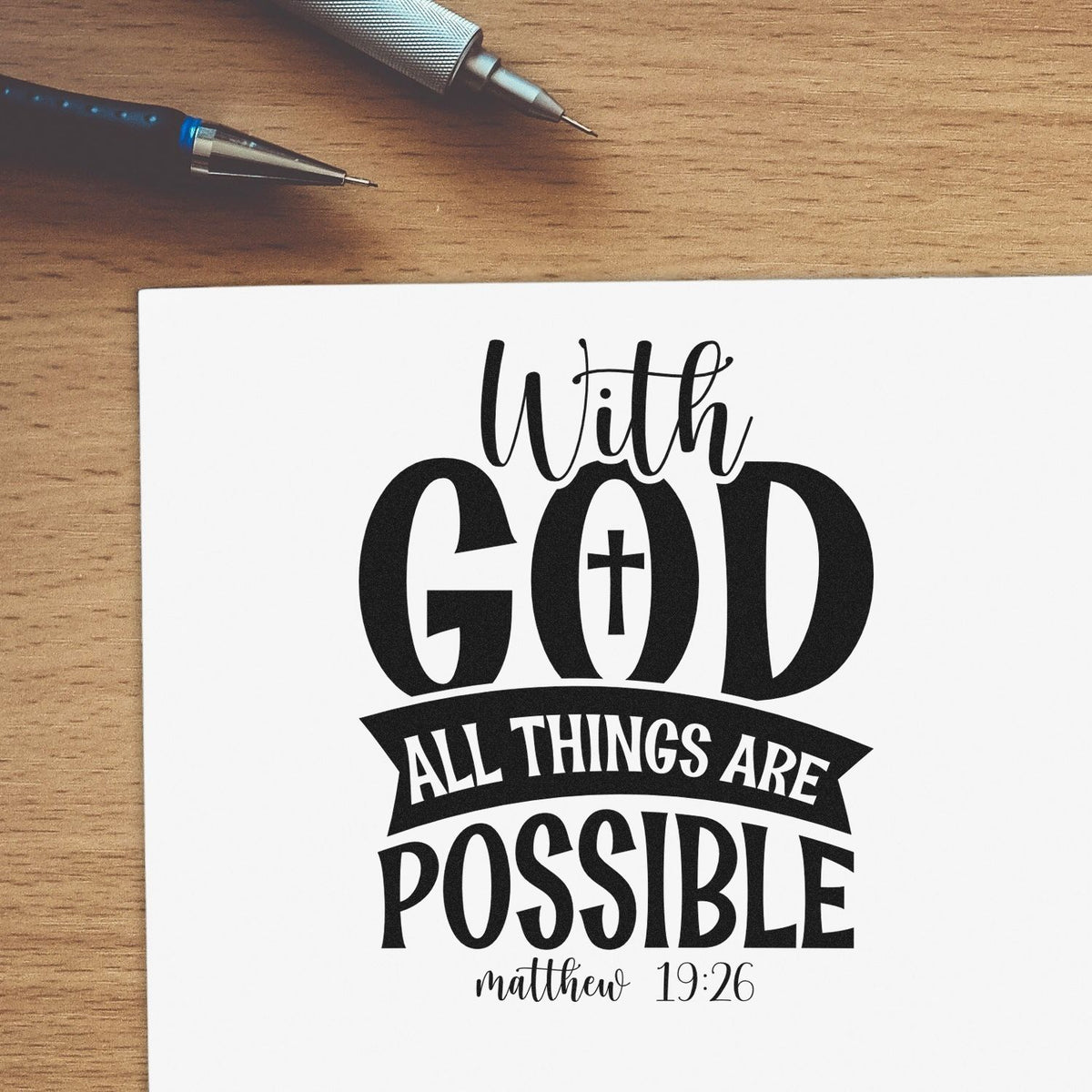 Christian rubber stamp design with With God all things are possible Bible verse and Matthew 19:26 on paper.