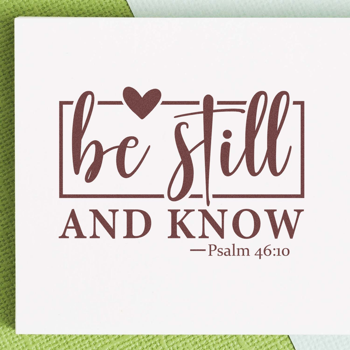 Christian rubber stamp design reading Be Still and Know with heart frame and Psalm 46:10 scripture.