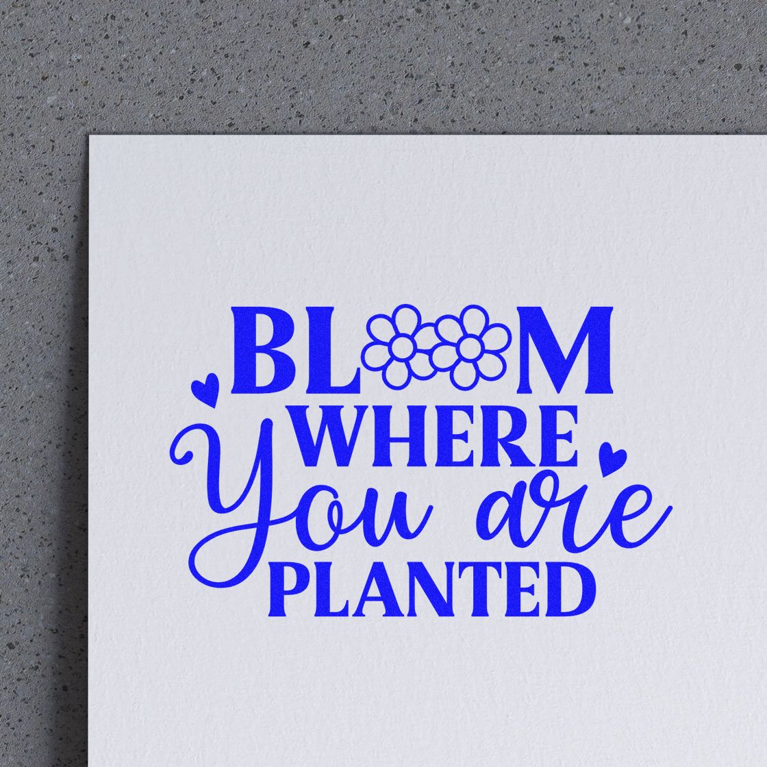 Blue rubber stamp design reading Bloom Where You Are Planted with floral accents, perfect for gardening and inspirational crafts.