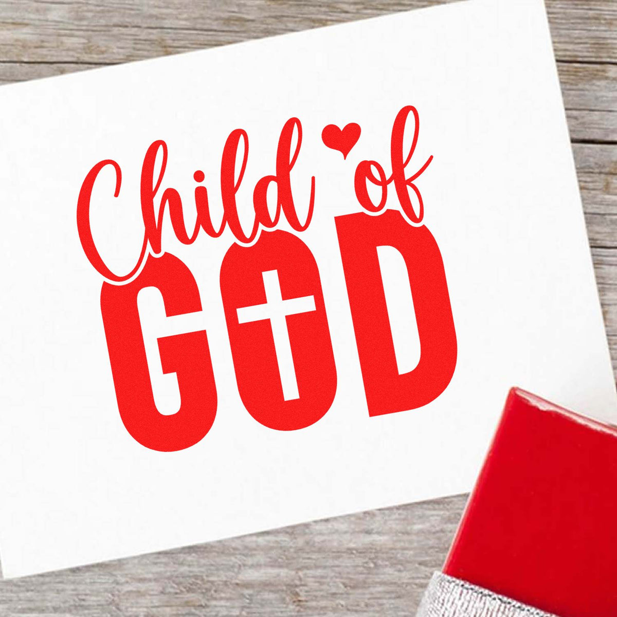 Red Child of God rubber stamp impression on white paper with stamp block, ideal for faith-based crafts and custom stationery.