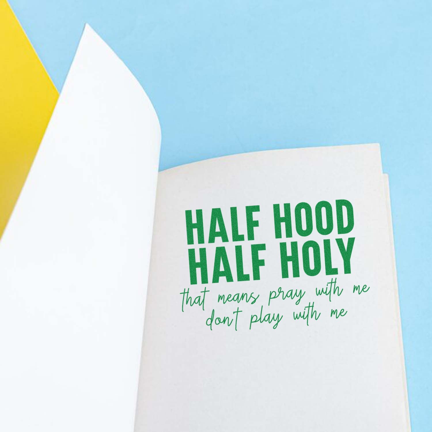 Funny Christian rubber stamp on card reading Half Hood Half Holy with a prayer-themed phrase in green lettering.
