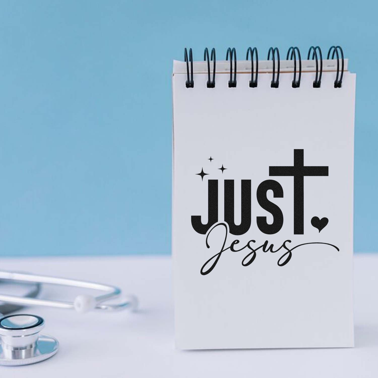 Christian Just Jesus rubber stamp design on spiral notepad for faith-based journaling and crafting.