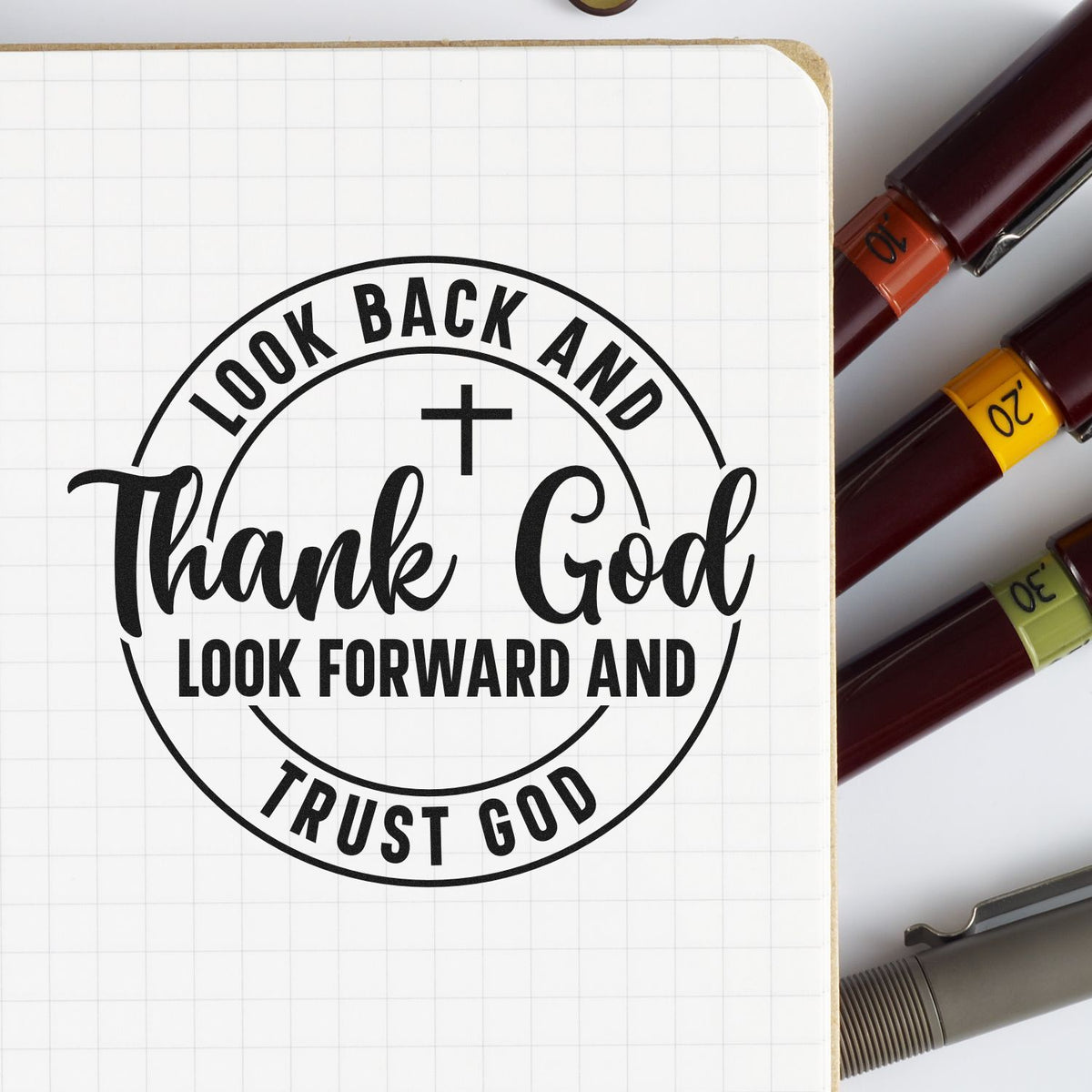 Inspirational Christian rubber stamp reading Look Back and Thank God, Look Forward and Trust God beside colorful stamp handles.