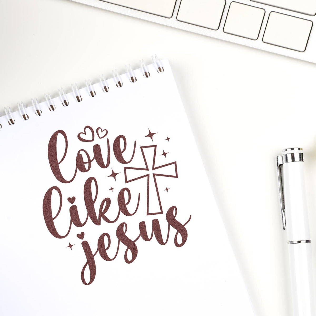 Love Like Jesus rubber stamp mockup on notebook paper, featuring a cross and hearts for Christian journaling and crafts.