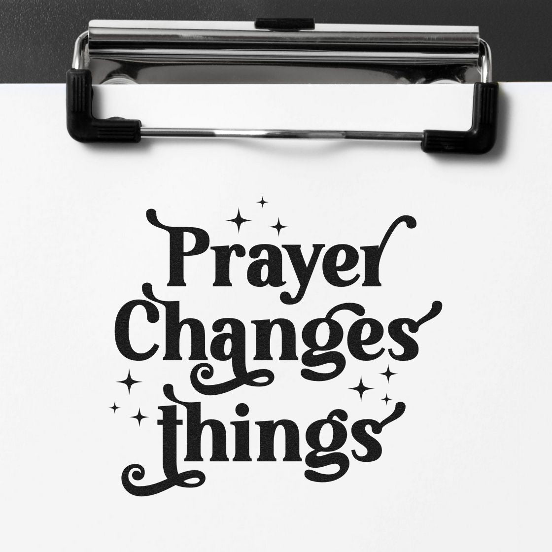 Prayer Changes Things rubber stamp on clipboard, decorative Christian sentiment quote for craft and faith projects.