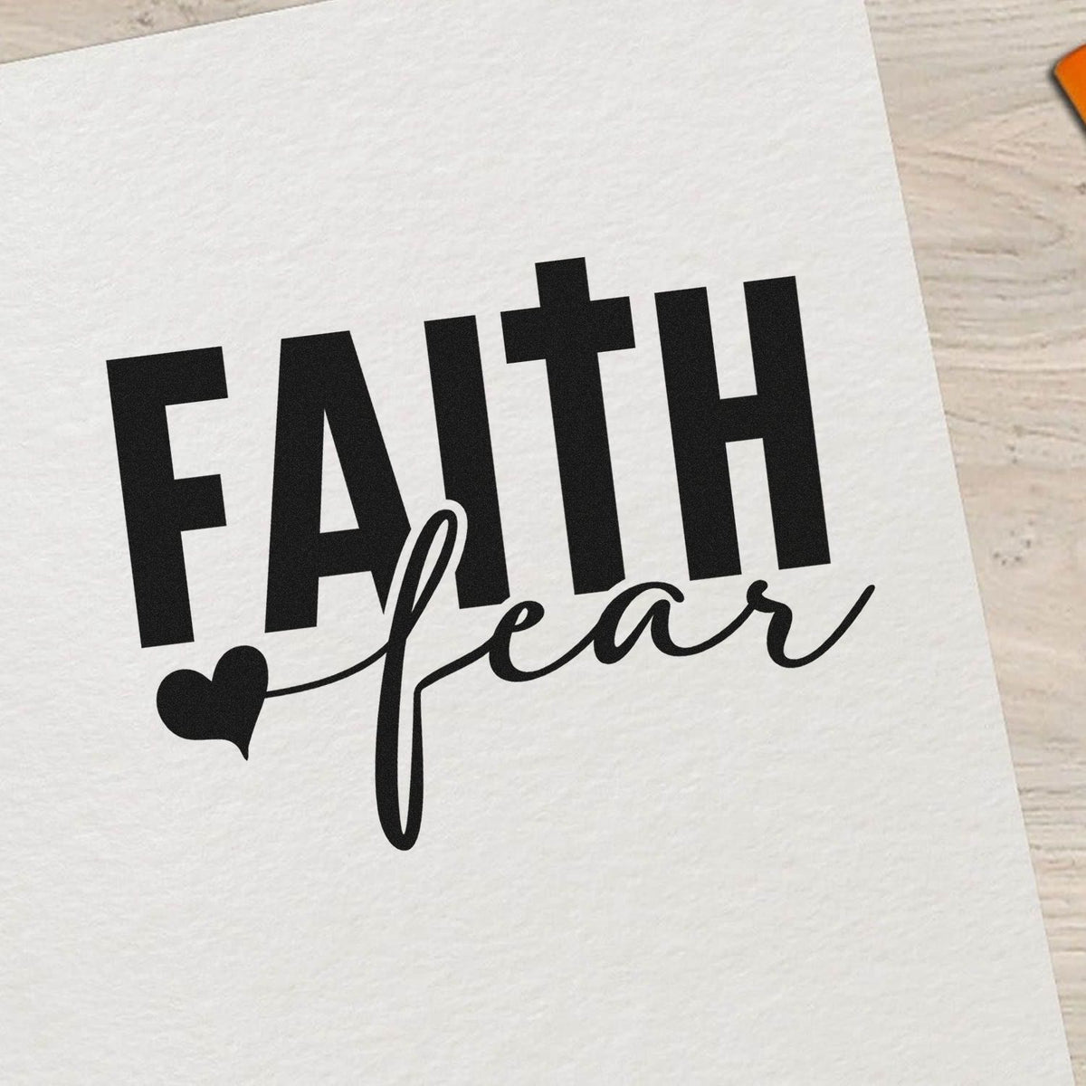 Faith over fear rubber stamp design with bold block lettering, script text, and heart accent for inspirational crafts.