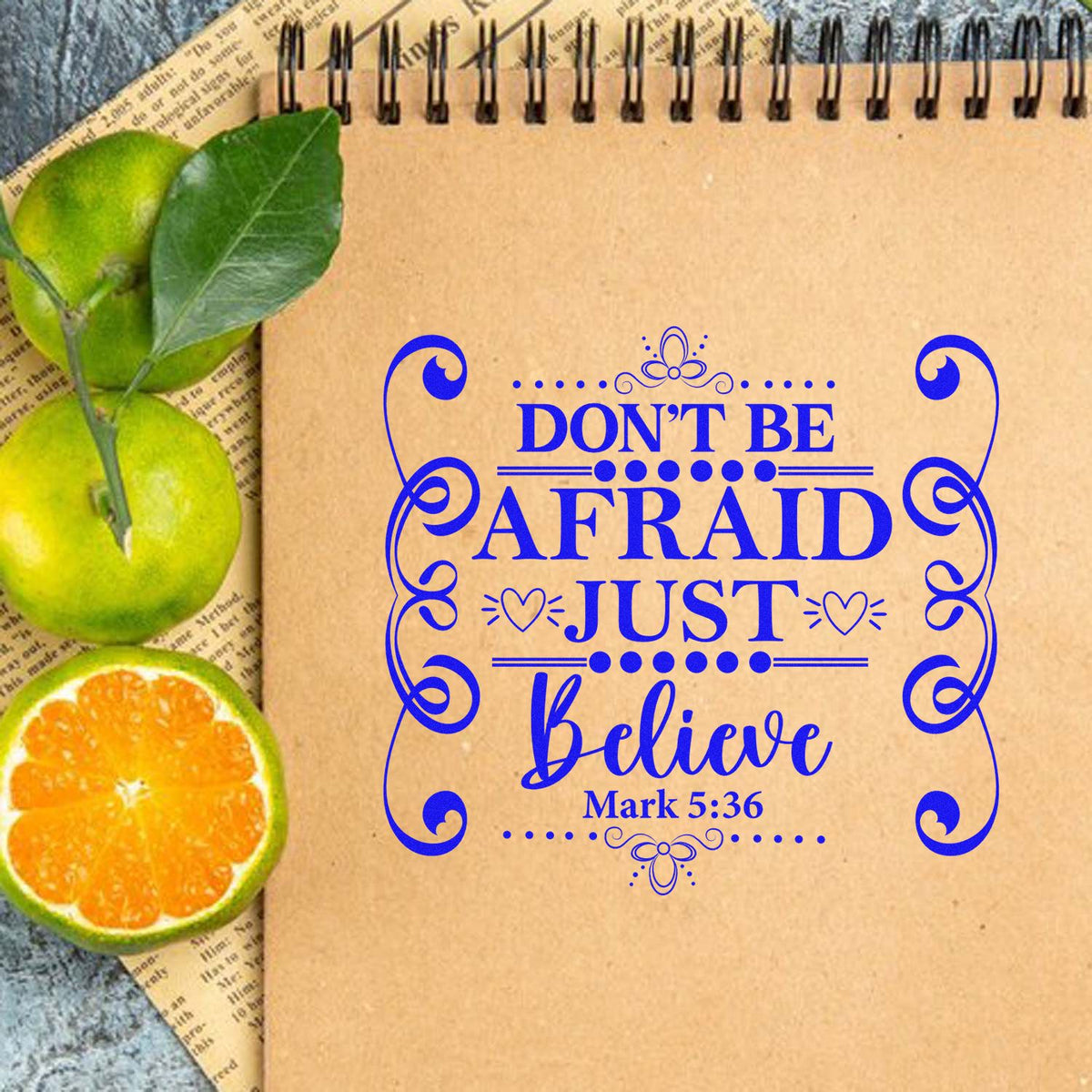 Christian rubber stamp design with Dont be afraid, just believe Mark 5:36 on kraft notebook with fruit accents.