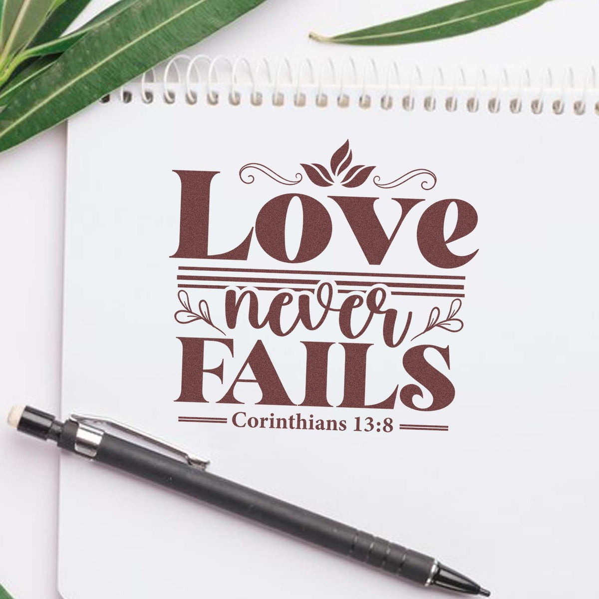 Custom rubber stamp design with Love Never Fails and Corinthians 13:8 for Christian crafts, journaling, and gifts.