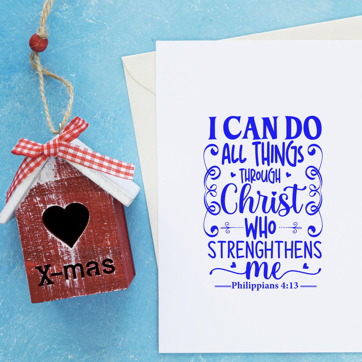 Christian Bible verse rubber stamp design with Philippians 4:13 sentiment and handmade X-mas birdhouse ornament on blue background.