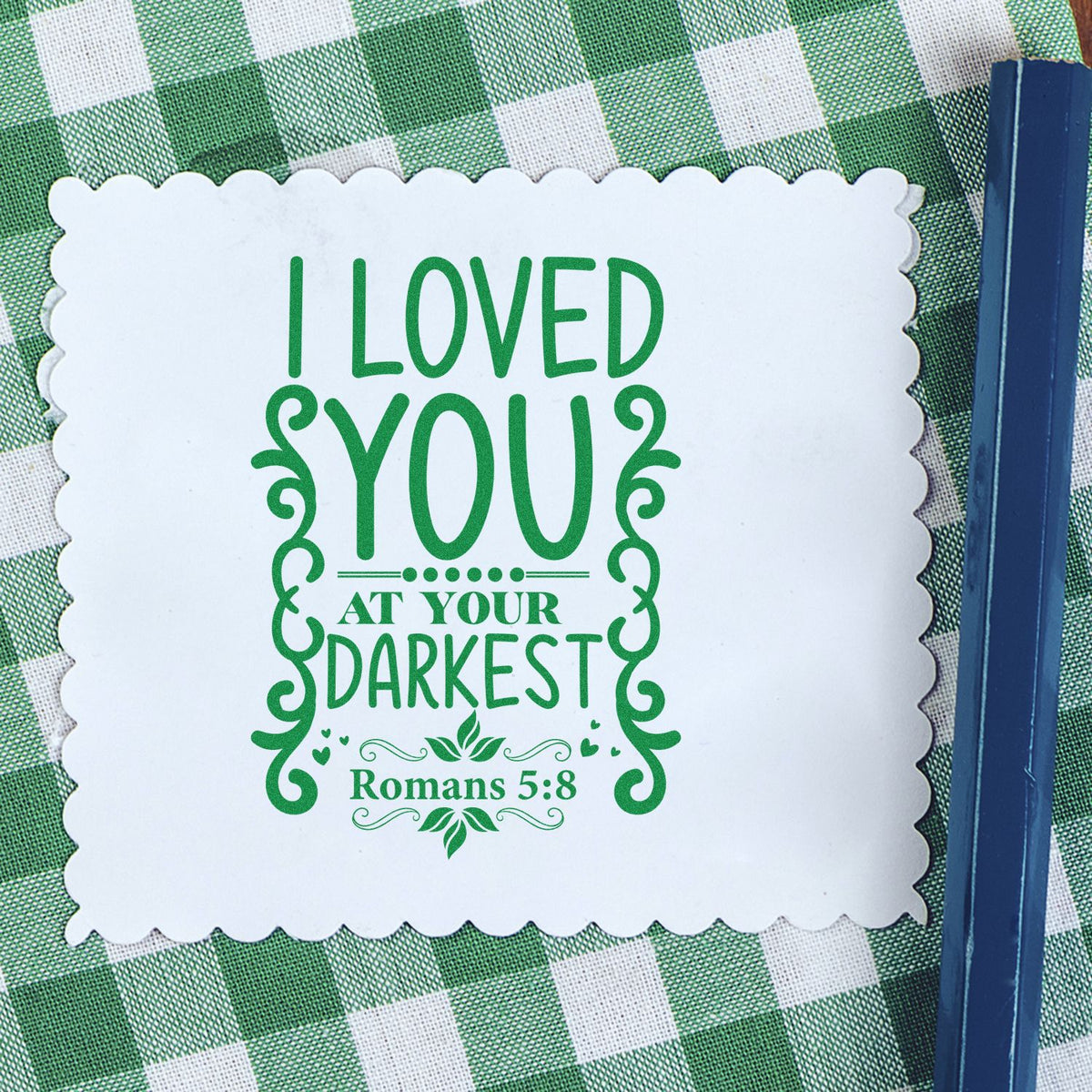 Christian rubber stamp impression with I Loved You at Your Darkest and Romans 5:8 verse design.