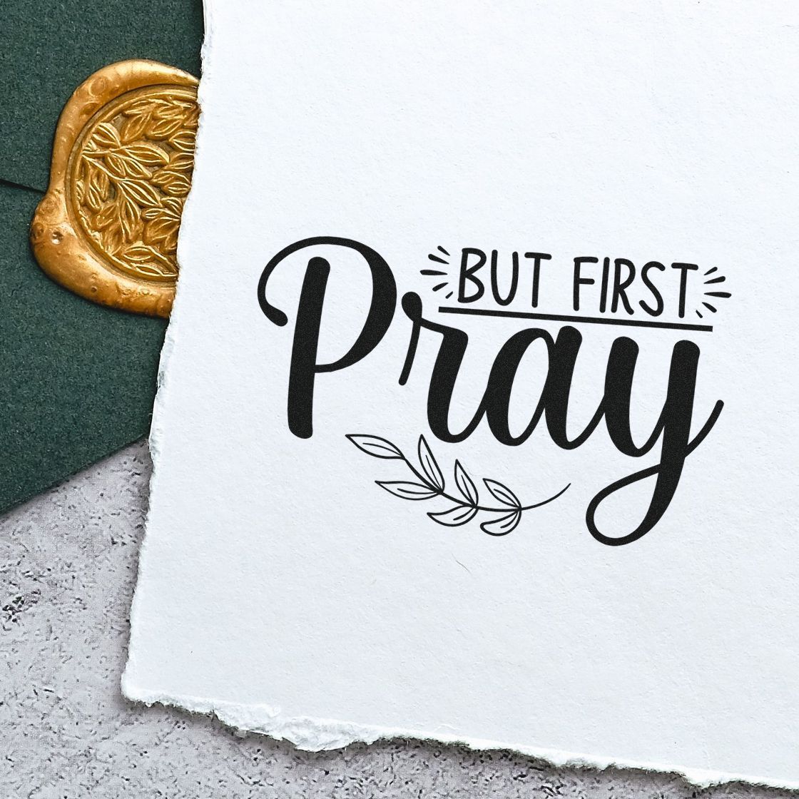 But First Pray rubber stamp design with leaf motif on handmade paper, ideal for faith-based journaling and DIY stationery.