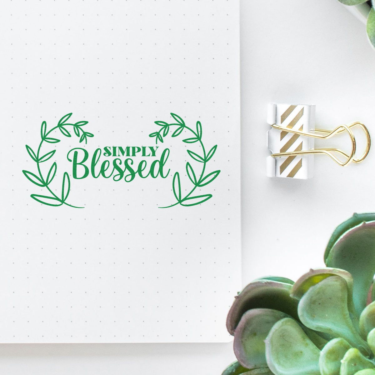 Simply Blessed wreath rubber stamp impression on dotted journal page, for faith-based planner and craft projects.