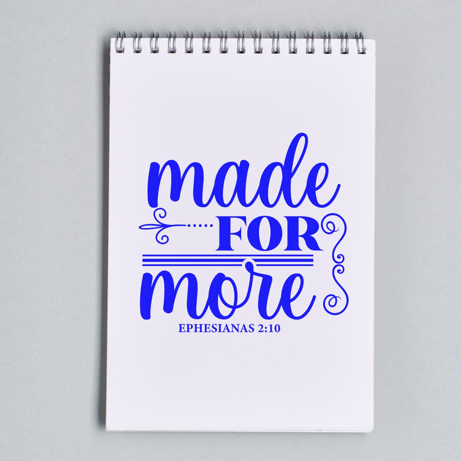 Christian rubber stamp design reading Made for More with Ephesians 2:10, stamped on a spiral notebook.