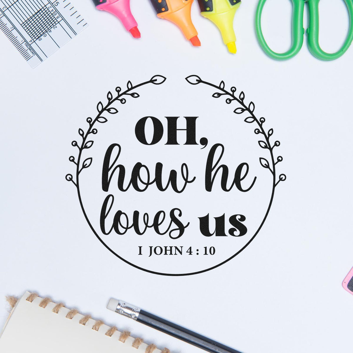 Christian rubber stamp design with Oh, how he loves us Bible verse from 1 John 4:10 in a leafy wreath.