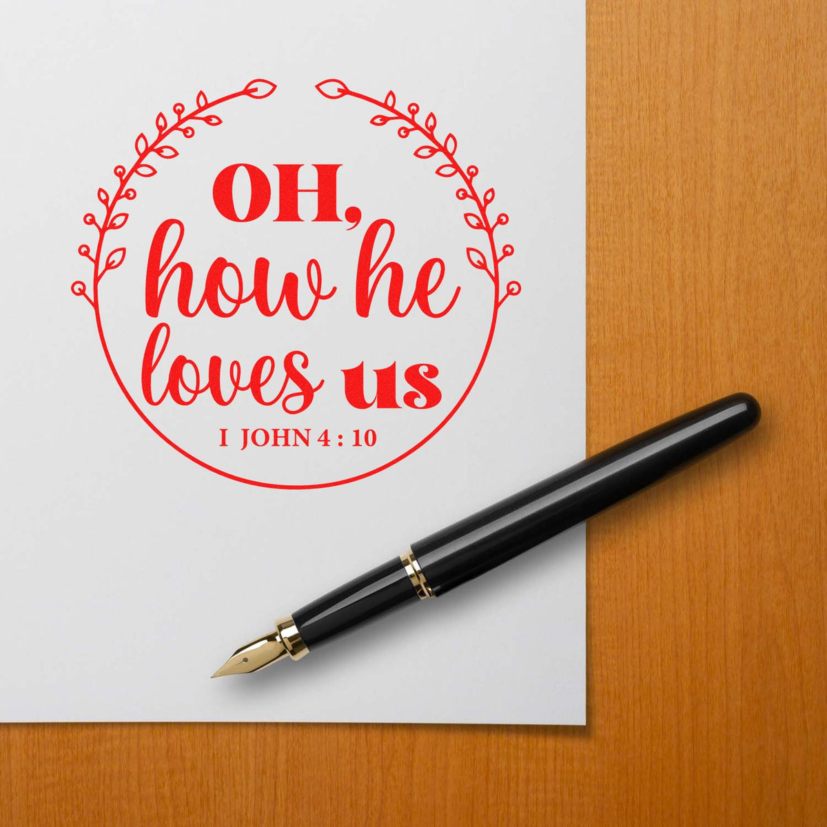 Christian rubber stamp design with Oh, how he loves us and John 4:10 scripture in a floral wreath.