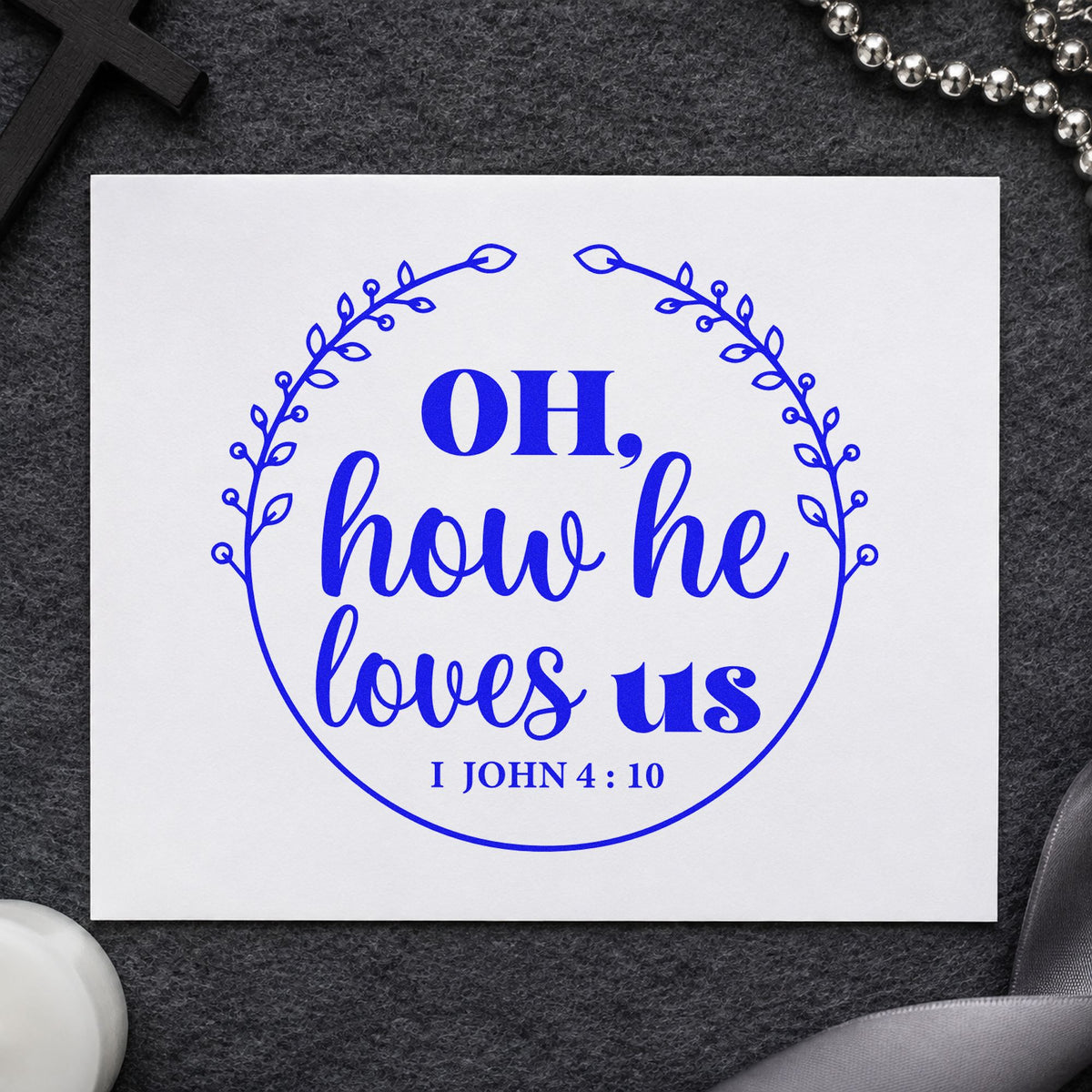 How He Loves Us Wreath craft stamp imprinted in blue ink on paper, a design suited to valentine cards.
