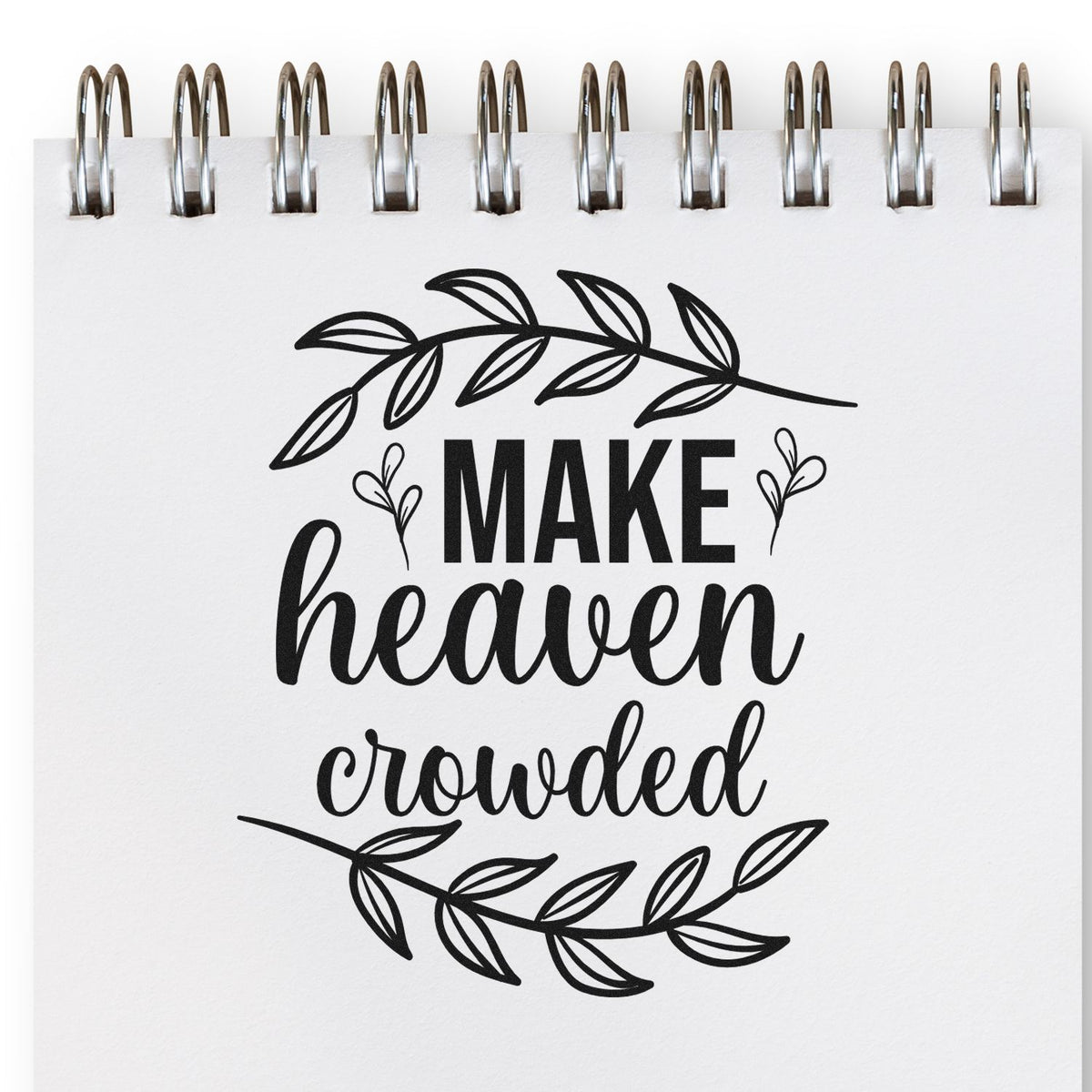 Make Heaven Crowded rubber stamp design with leafy botanical wreath on a spiral notebook page.