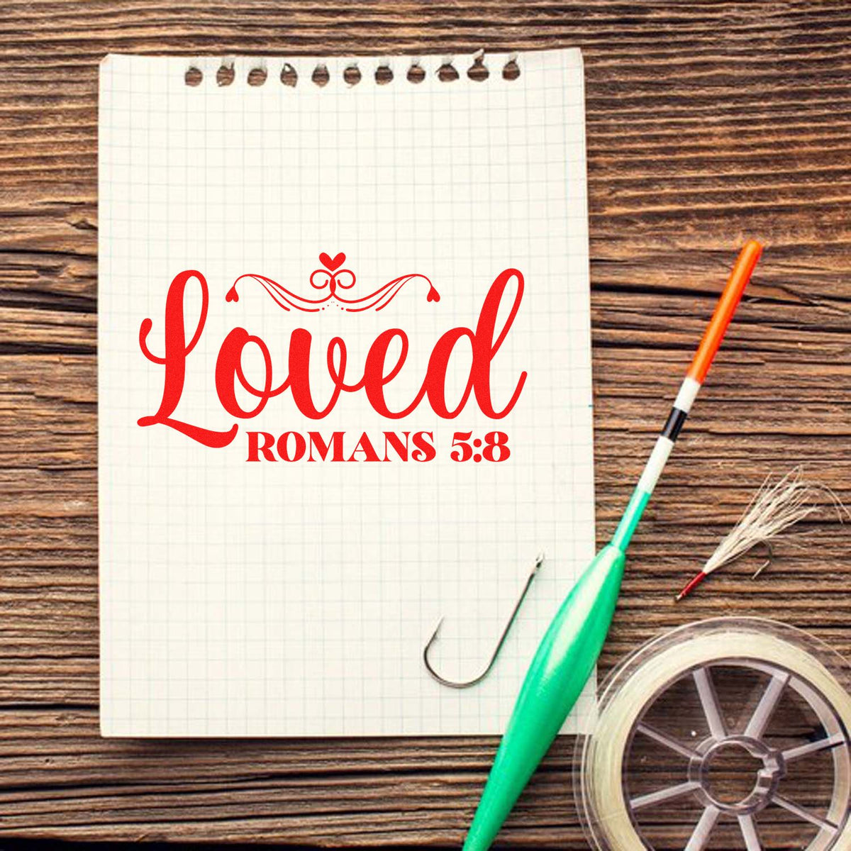 Bible verse rubber stamp with Loved Romans 5:8 design on notebook paper, ideal for Christian crafts.