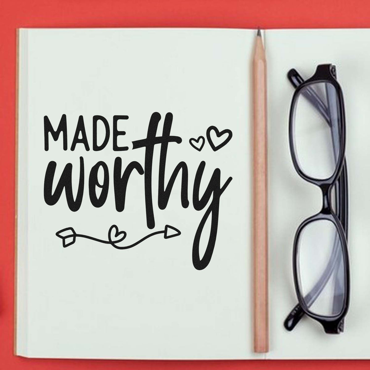 Made Worthy rubber stamp design on notebook with pencil and glasses, inspirational affirmation for journaling and planners.
