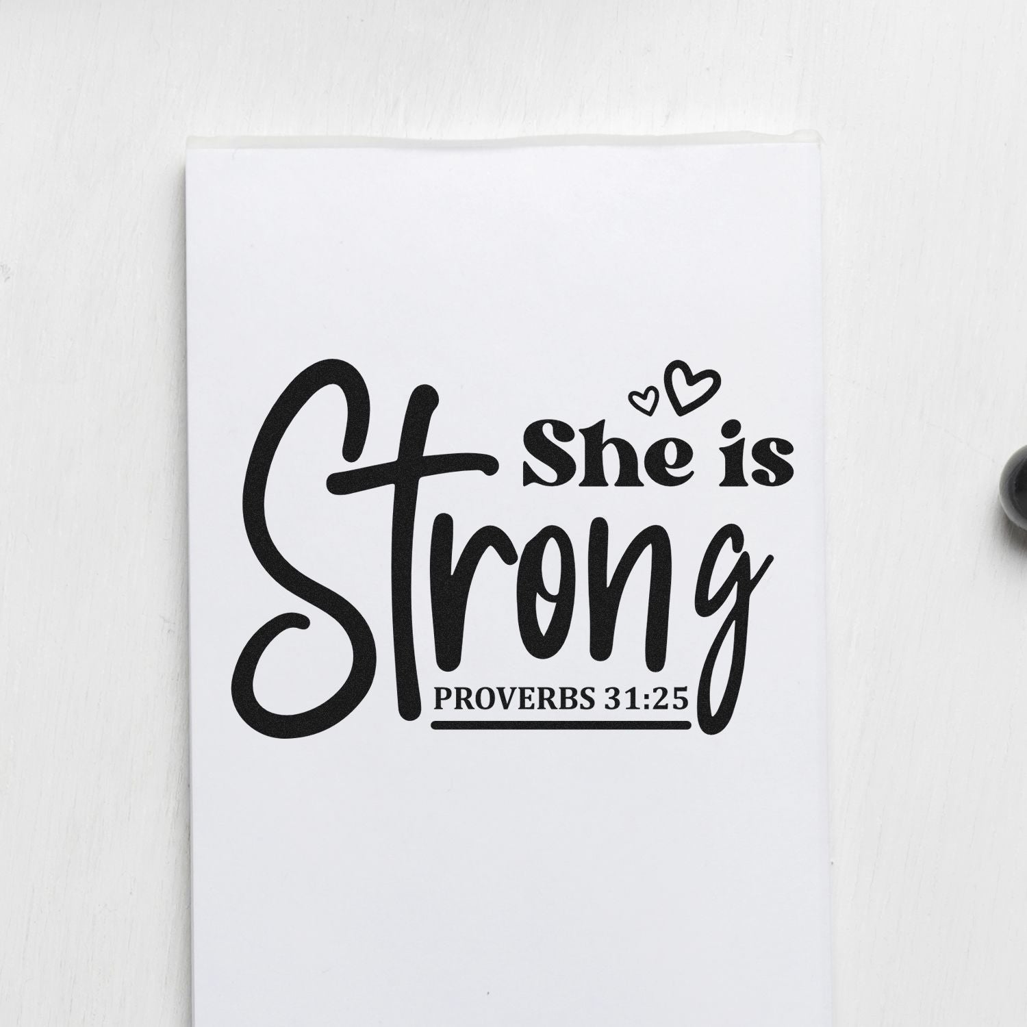 Christian rubber stamp design reading She is Strong with Proverbs 31:25 and heart accents for faith-based crafts.