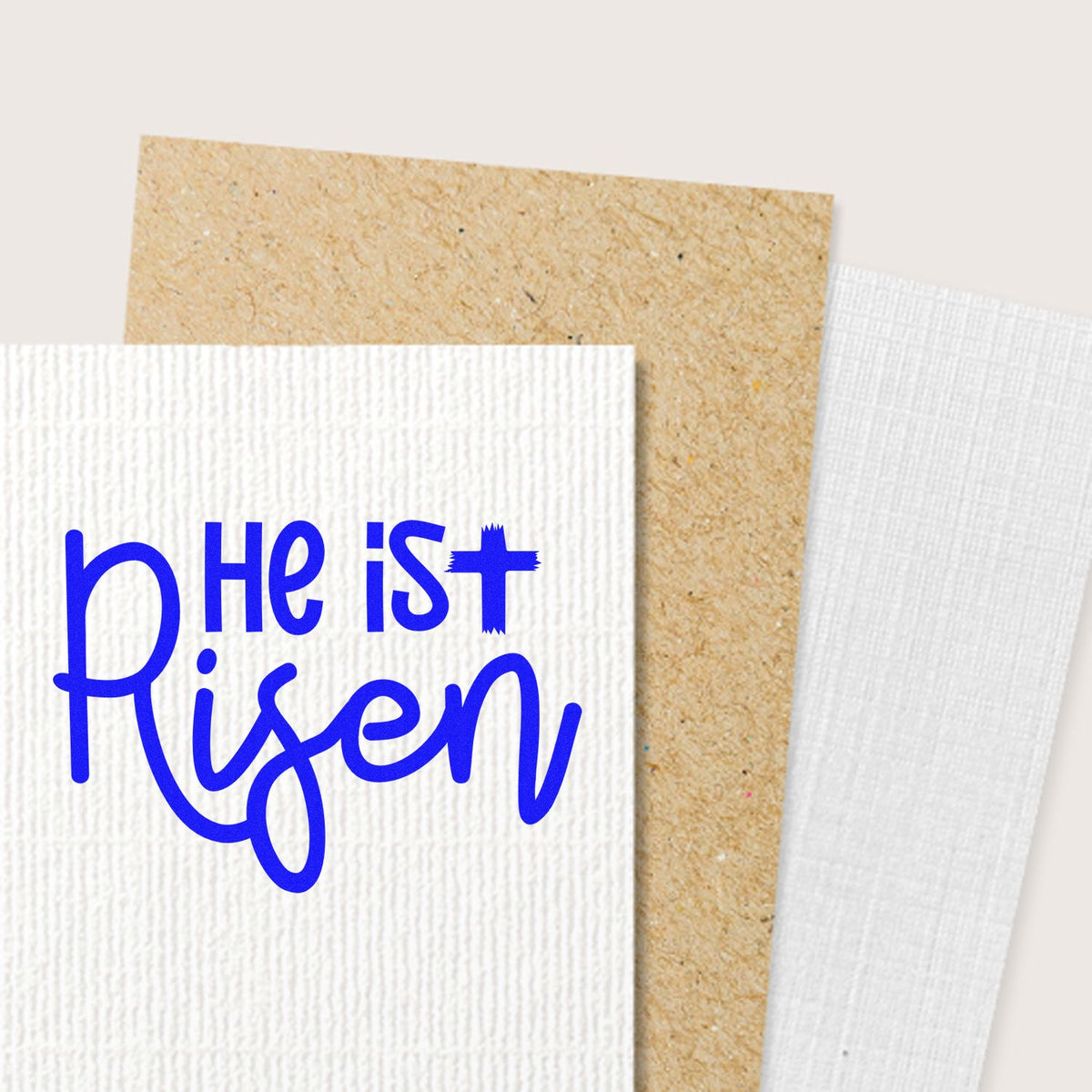 He Is Risen rubber stamp on textured cardstock, perfect for Easter cards and Christian craft projects.