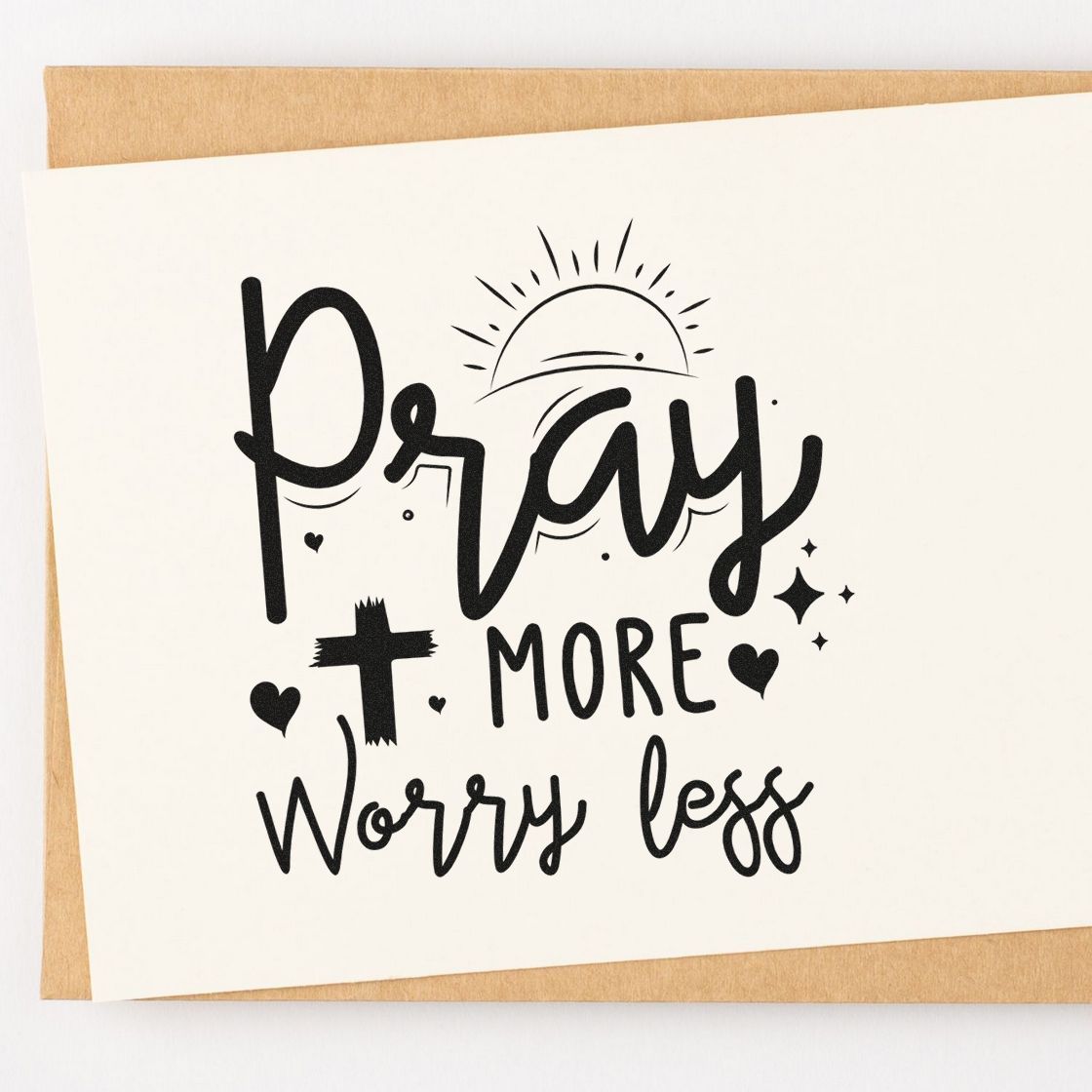 Christian rubber stamp design reading Pray More Worry Less with sunburst, hearts, and decorative script for faith-based crafts.