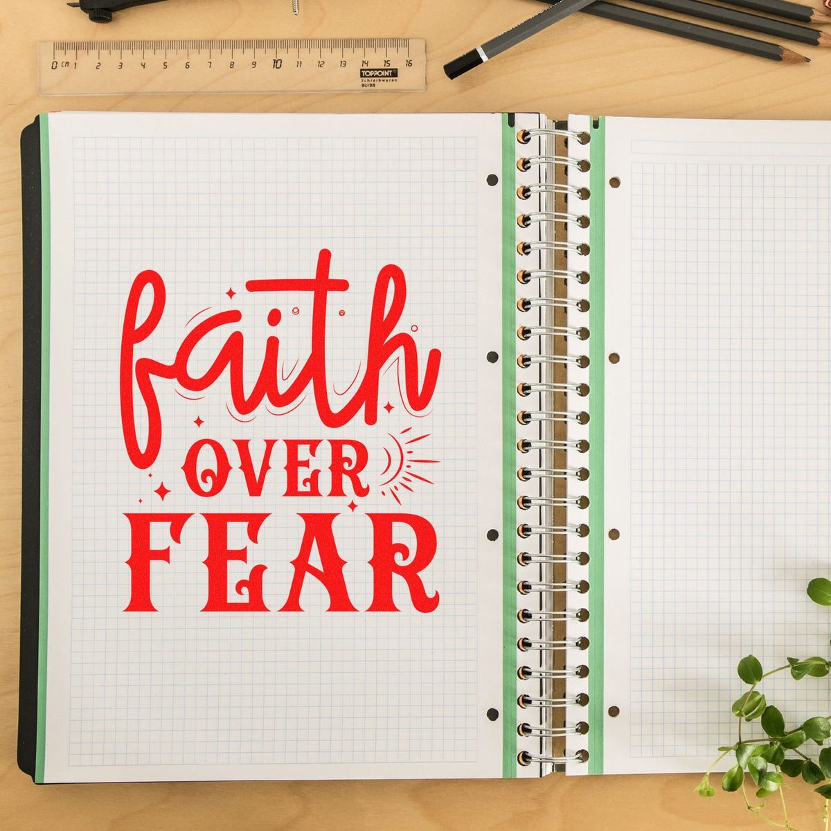 Faith over fear rubber stamp design in red on an open notebook page, perfect for inspirational journaling and Bible crafts.