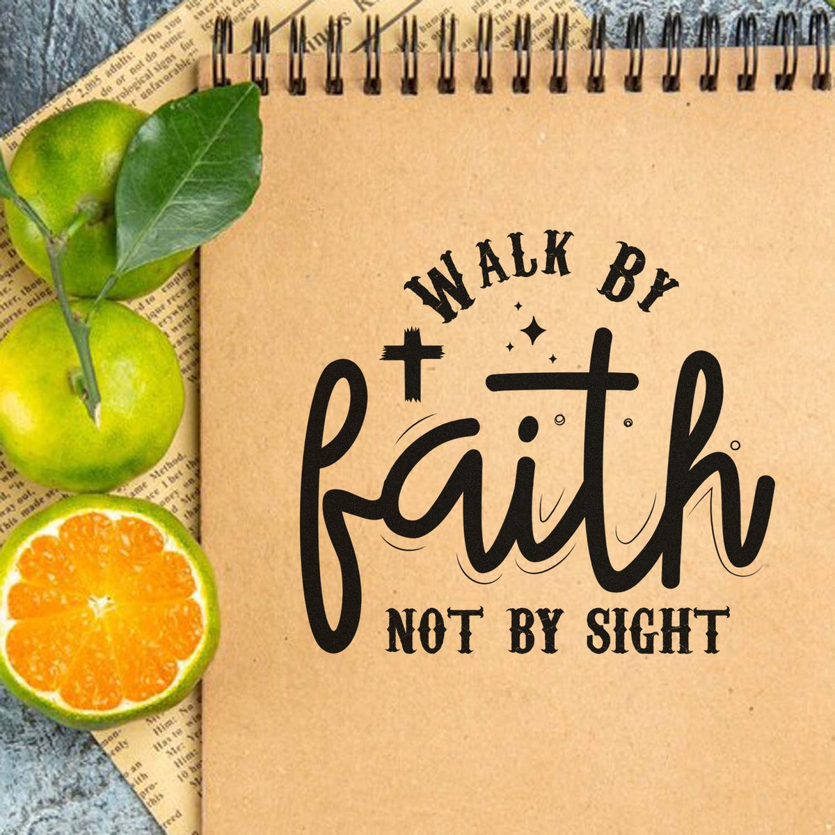Custom rubber stamp design with Walk by Faith Not by Sight on kraft notebook, featuring citrus and leafy accents.