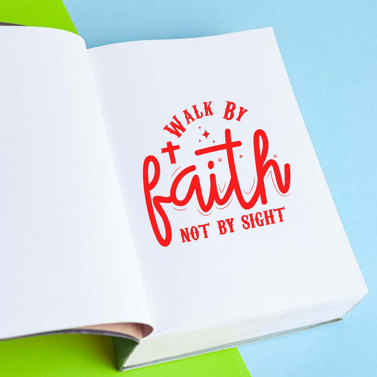 Red Walk by Faith, Not by Sight rubber stamp on open book page.