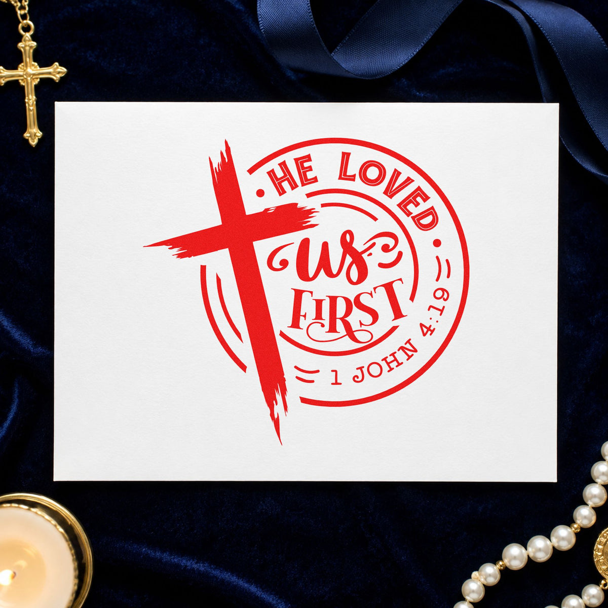 He Loved Us First Round rubber stamp shown in red ink, stamped for projects such as backpack ministry tags.