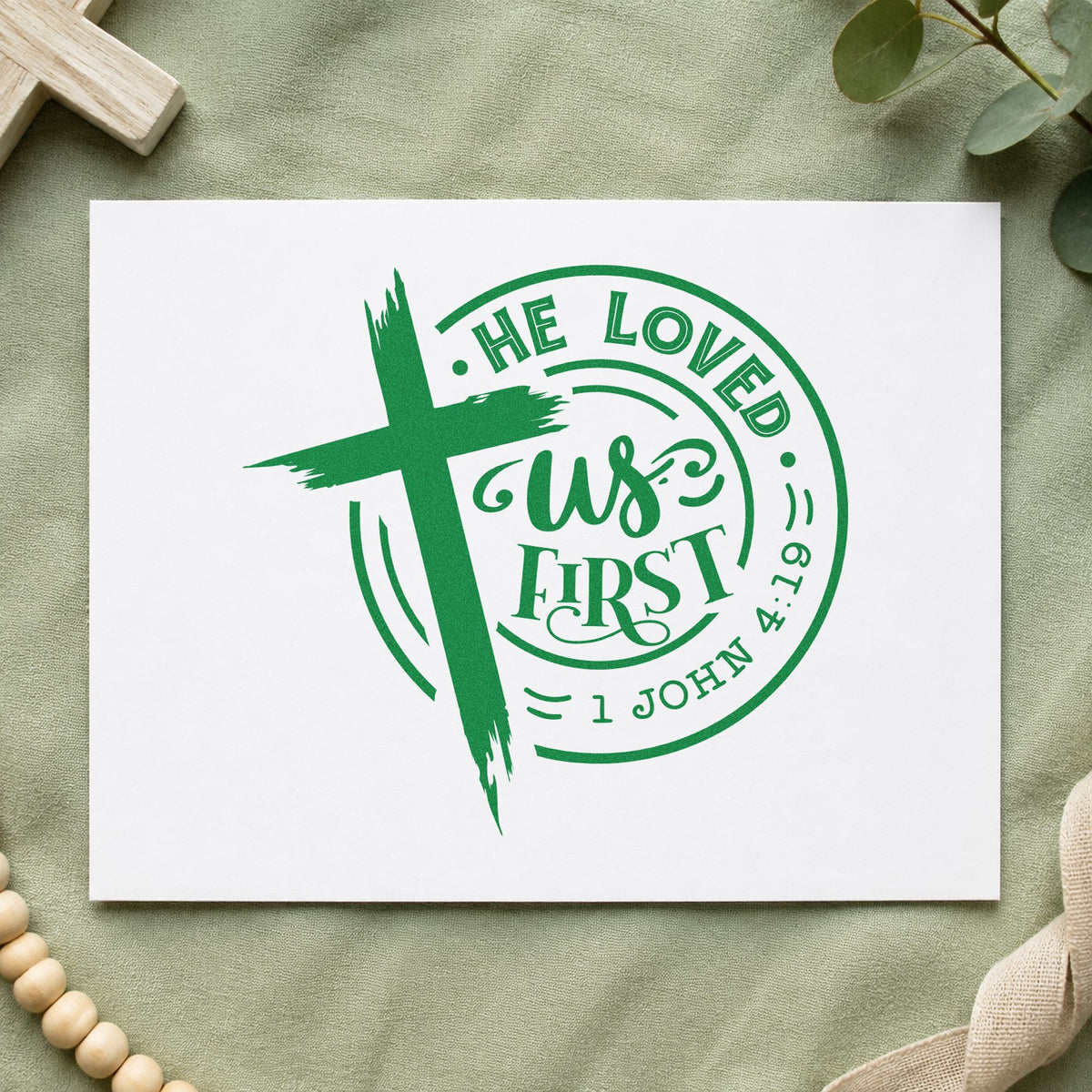 He Loved Us First Round craft stamp imprint in green ink on a handmade project, one idea being framed stairwell art.
