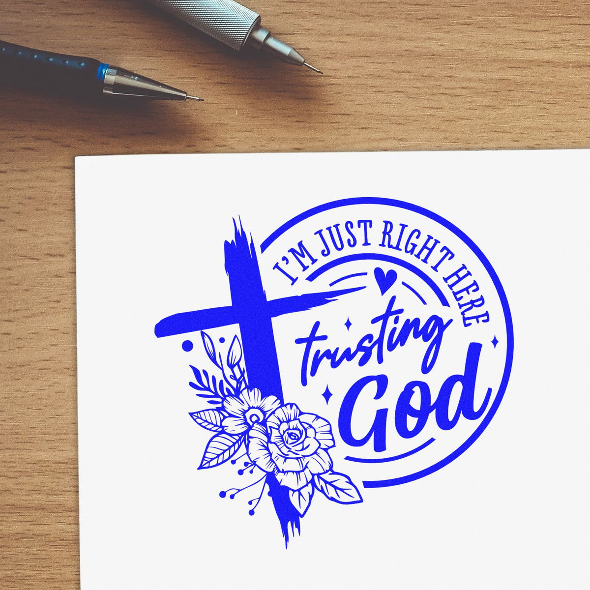 Christian rubber stamp design reading Im just right here trusting God with cross, flowers, and blue ink on white paper.