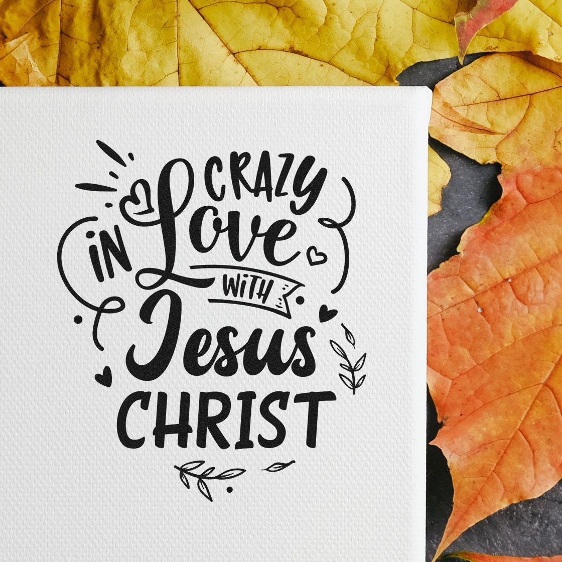 Christian rubber stamp impression reading Crazy in Love with Jesus Christ on paper, with hearts and leaves for Bible journaling.