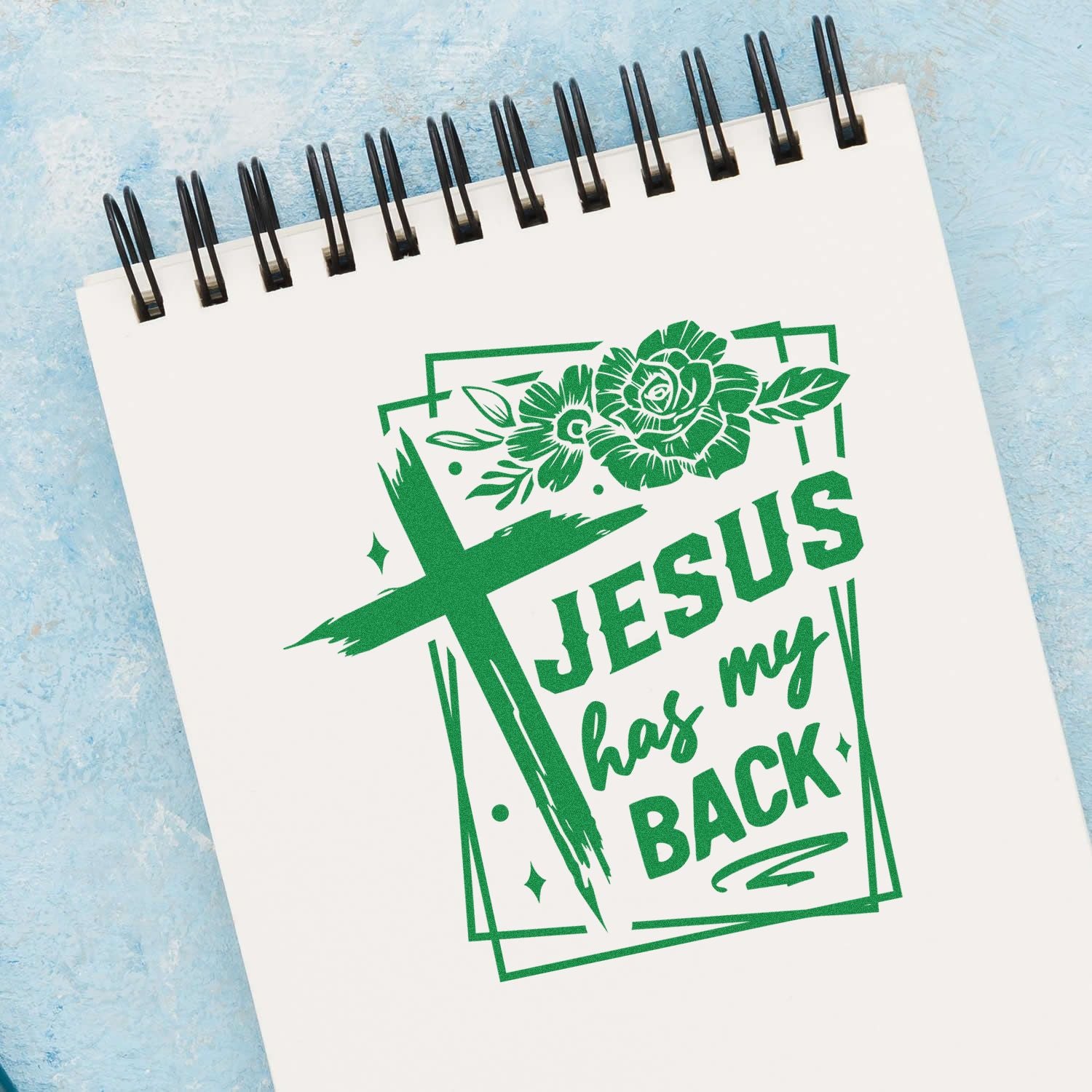 Christian rubber stamp design with cross and floral accents reading Jesus has my back for faith-based crafts and journaling.