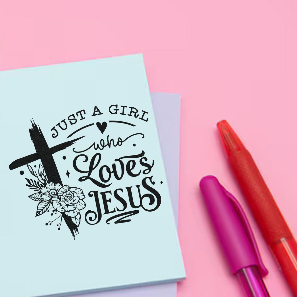 Christian rubber stamp design reading Just a girl who loves Jesus with cross and floral accents on pastel stationery.
