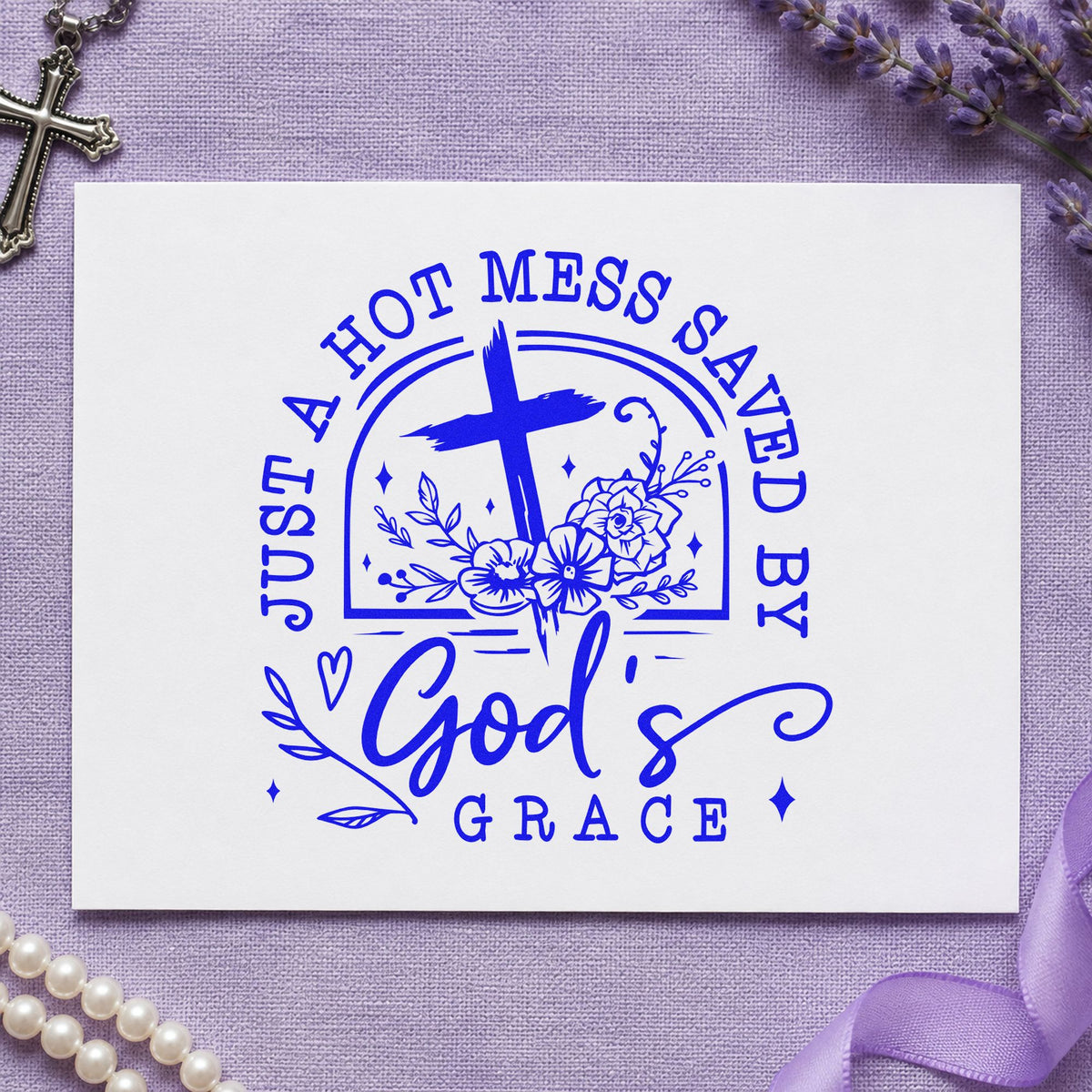 Hot Mess Saved by Grace craft stamp imprinted in blue ink on paper, a design suited to craft fair banners.