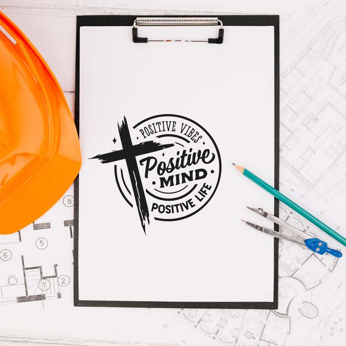 Positive Mind, Positive Life rubber stamp design on clipboard with drafting tools and hard hat for construction branding.