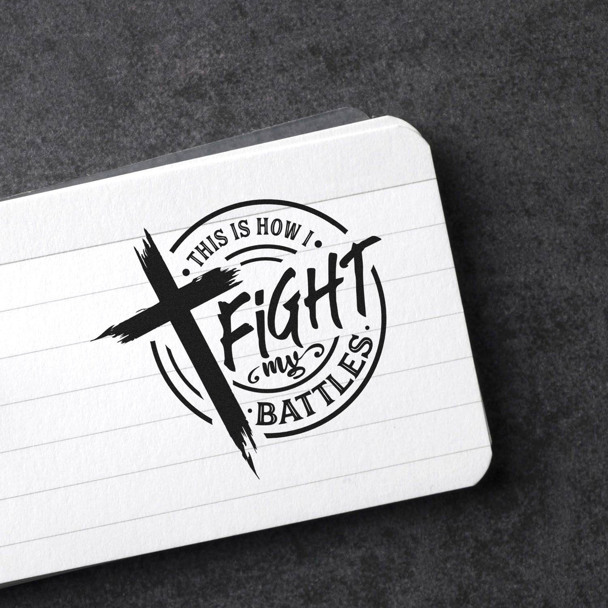 Custom rubber stamp design with Christian cross quote, This is how I fight my battles, stamped on notebook paper.