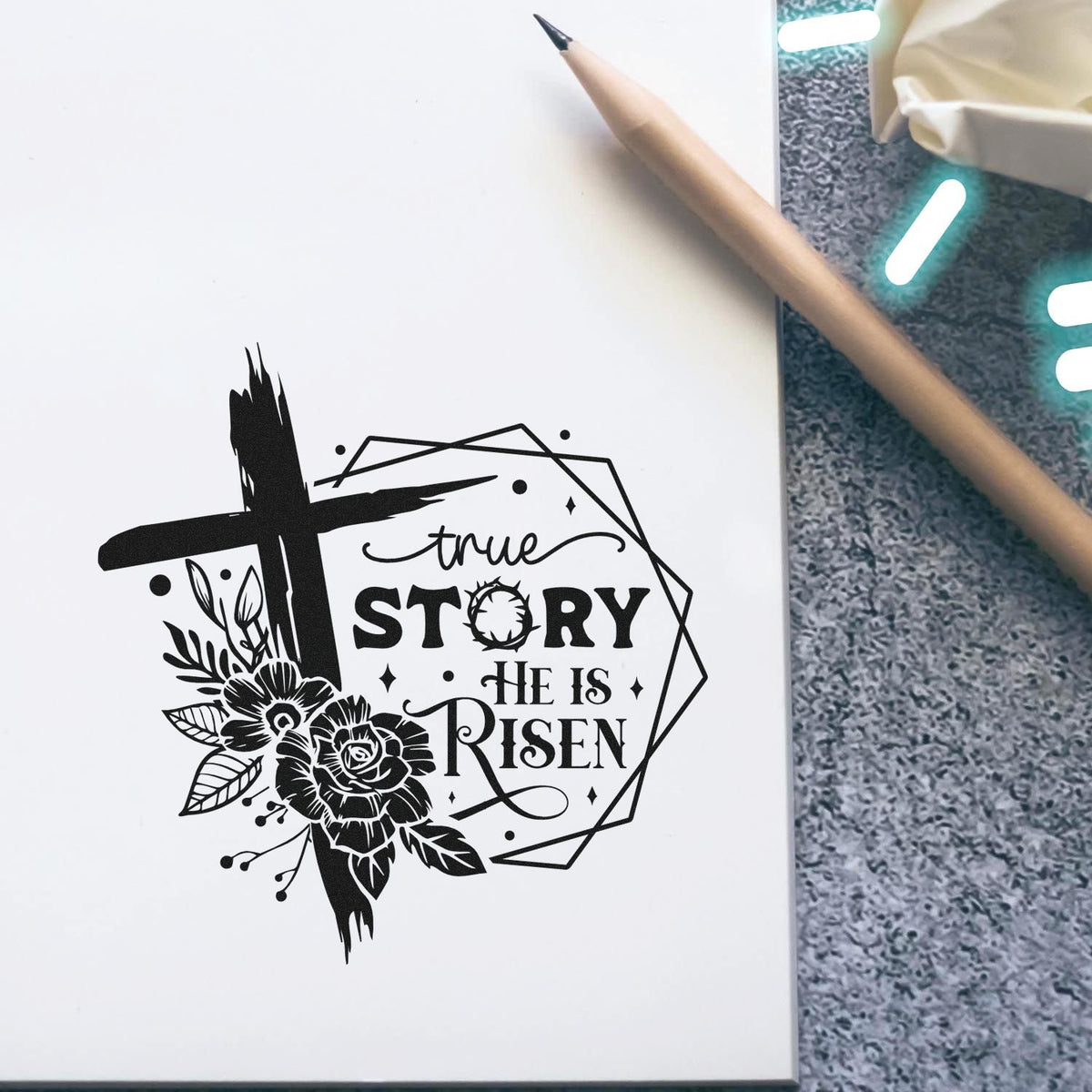Slim Pre-Inked True Story Risen Rose Frame Stamp imprint stamped in black ink. A brushstroke cross and dark roses overlap a geometric frame reading "True story, he is risen."
