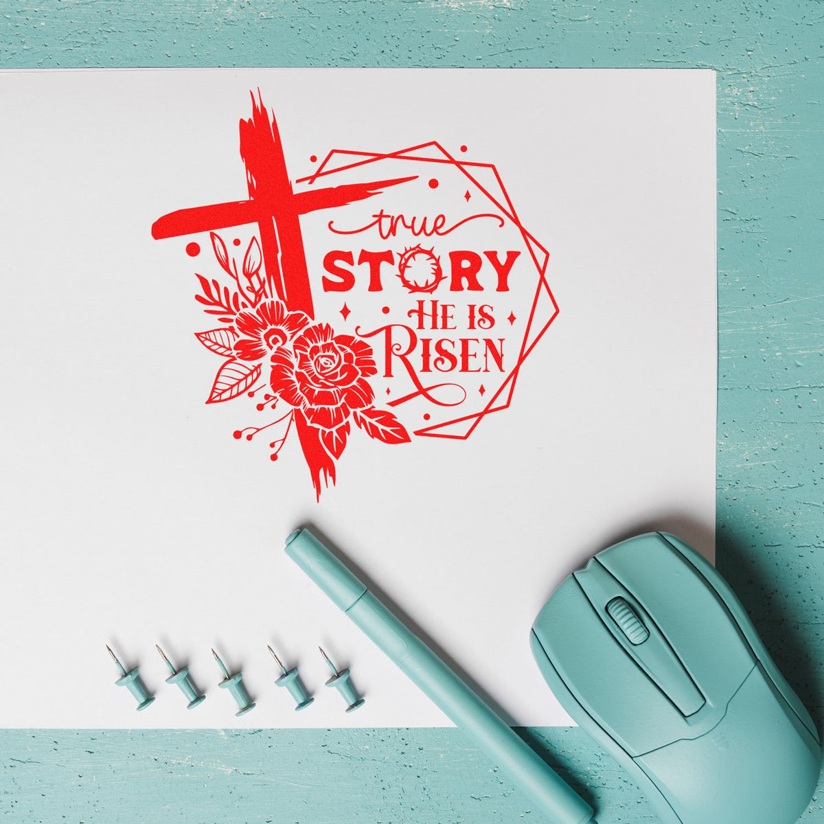 Easter rubber stamp design reading True Story He Is Risen with cross, flowers, and crafting tools on a paper workspace.
