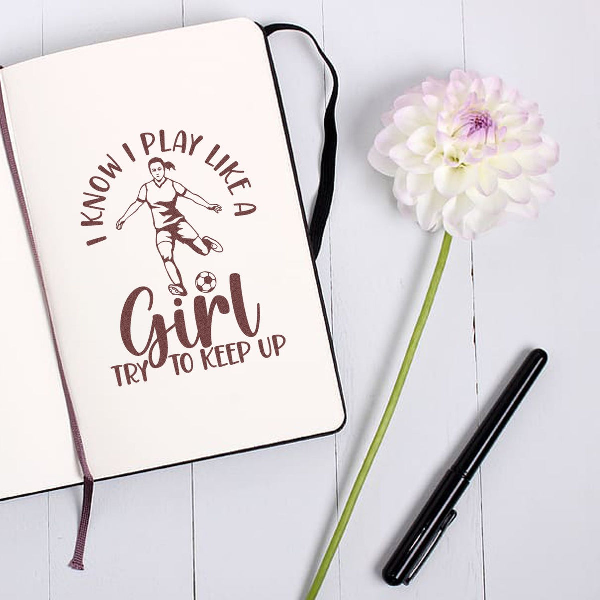 Soccer girl rubber stamp mockup with I know I play like a girl, try to keep up design on notebook.