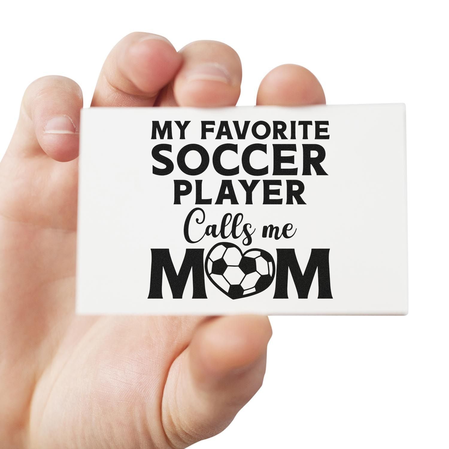 Hand holding a custom rubber stamp reading My favorite soccer player calls me mom with soccer ball heart design.
