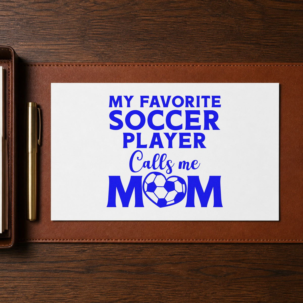 Favorite Soccer Player Calls Me Mom craft stamp imprinted in blue ink on paper, a design suited to tournament bag bands.
