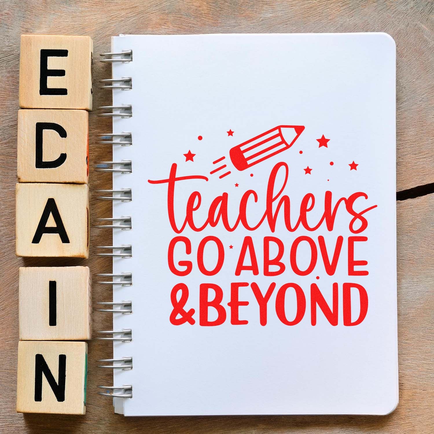 Teacher rubber stamp design featuring a pencil icon and teachers go above & beyond on a spiral notebook.