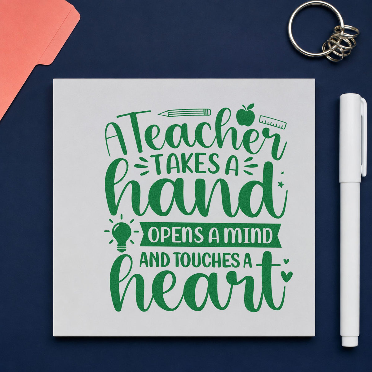 Teacher Touches a Heart craft stamp imprint in green ink on a handmade project, one idea being framed office wall.