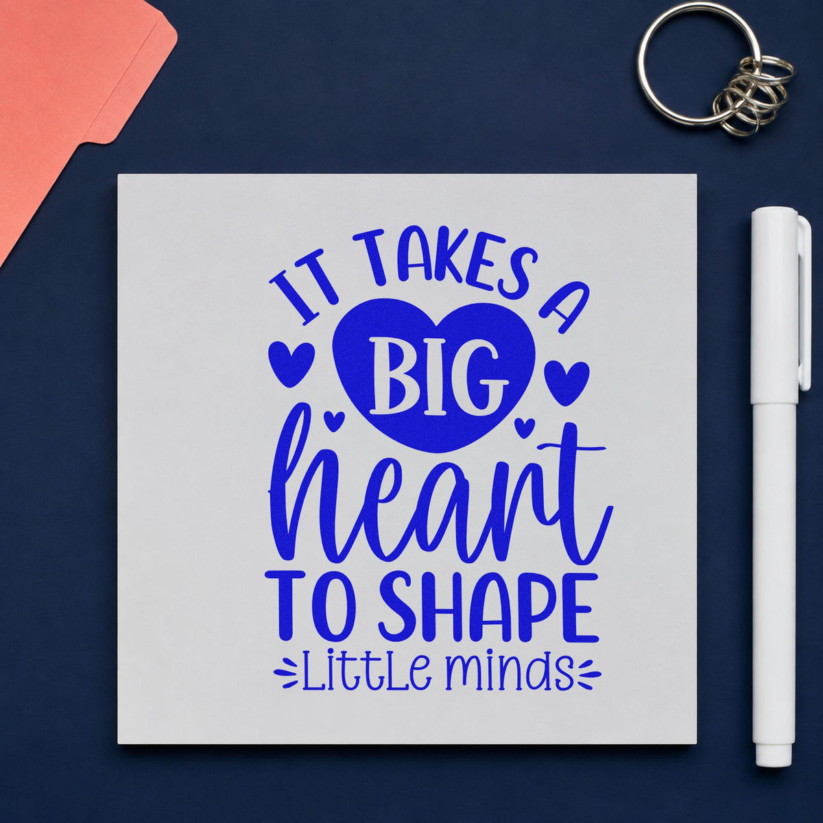 Big Heart Shapes Little Minds craft stamp in blue ink on cardstock, an easy option for smock chest panels.