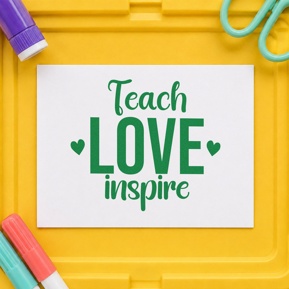 Teach Love Inspire craft stamp imprint in green ink on a handmade project, one idea being bulletin board pages.