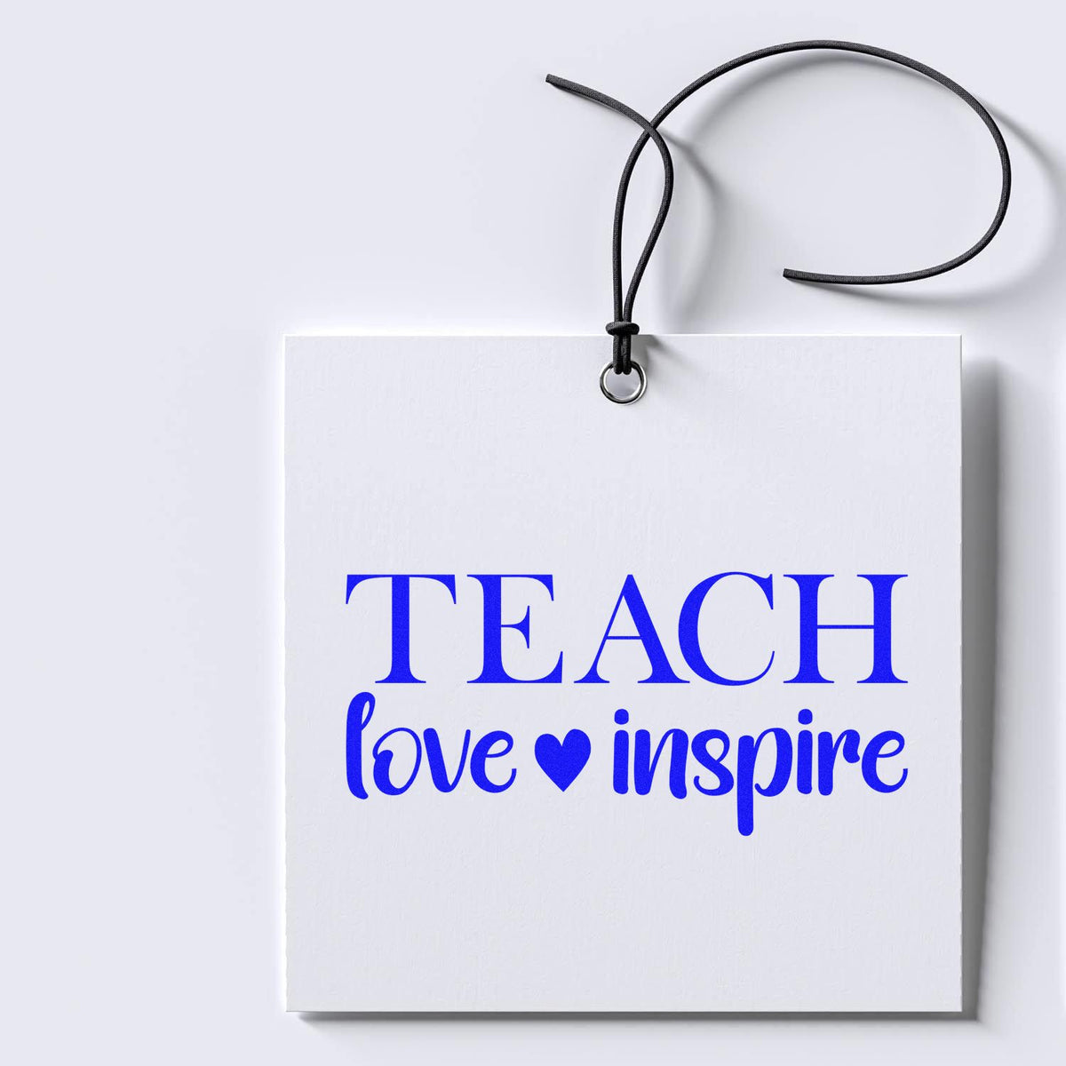 Teach Love Inspire rubber stamp design on a hanging gift tag, perfect for teacher gifts, classroom crafts, and school projects.